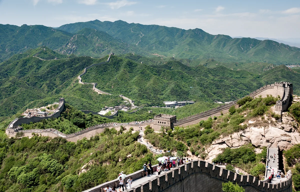 Great Wall of China winding over green ridges at Badaling near Beijing