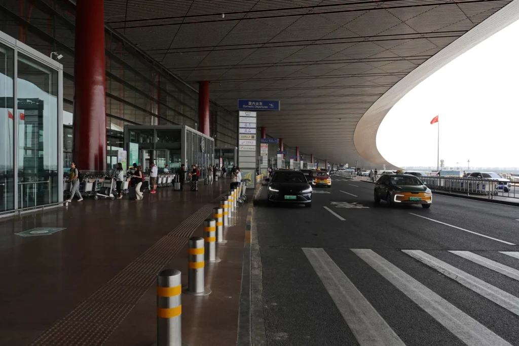 Terminal 3 at Beijing Capital International Airport, with taxis waiting at the curb