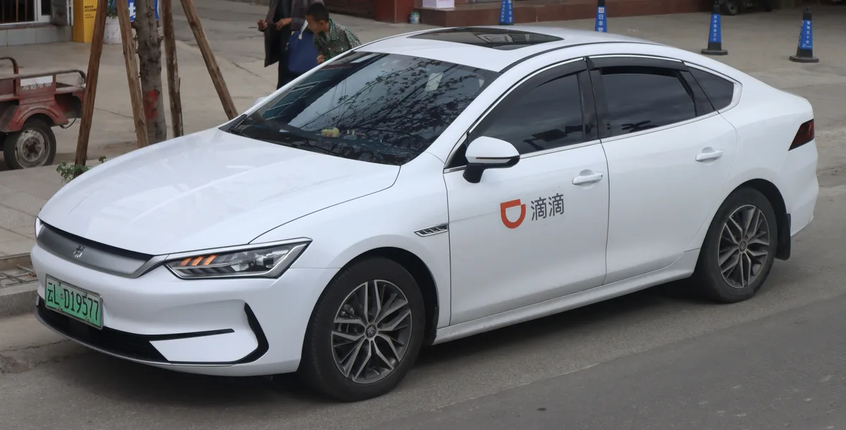 White DiDi ride-hailing car on a street in Dali, Yunnan