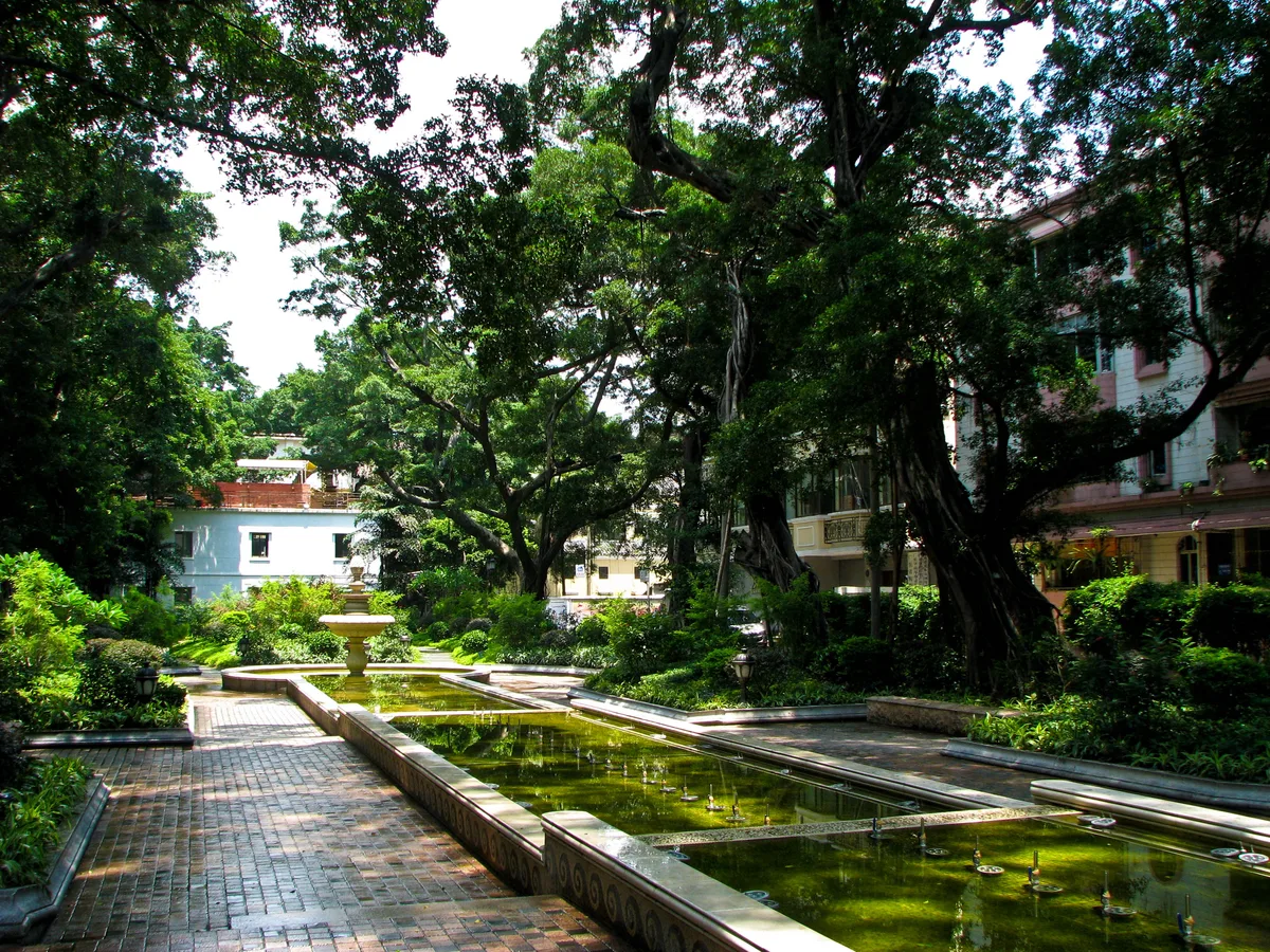 Shaded path, fountain, and older buildings on Shamian Island in Guangzhou